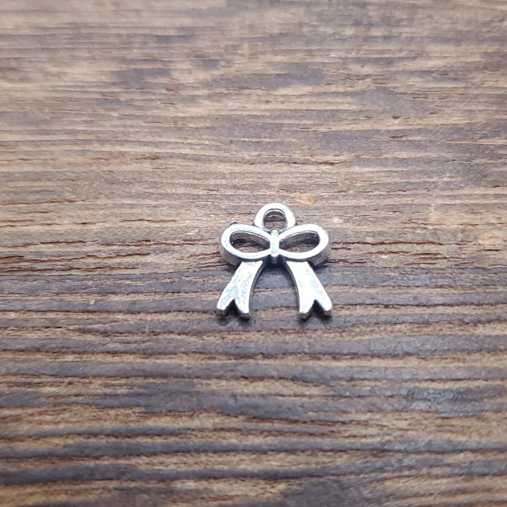 Delicate small sterling ribbon charm P136